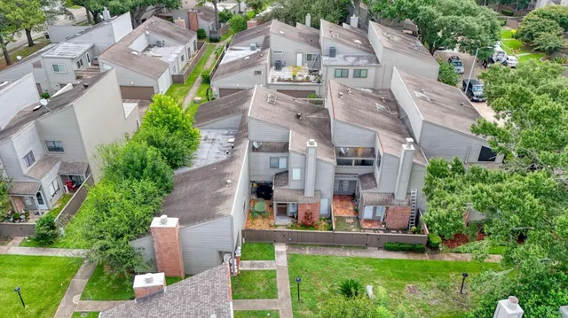 an aerial view of multiple houses with yard