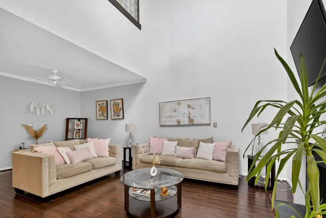 a living room with furniture and wooden floor