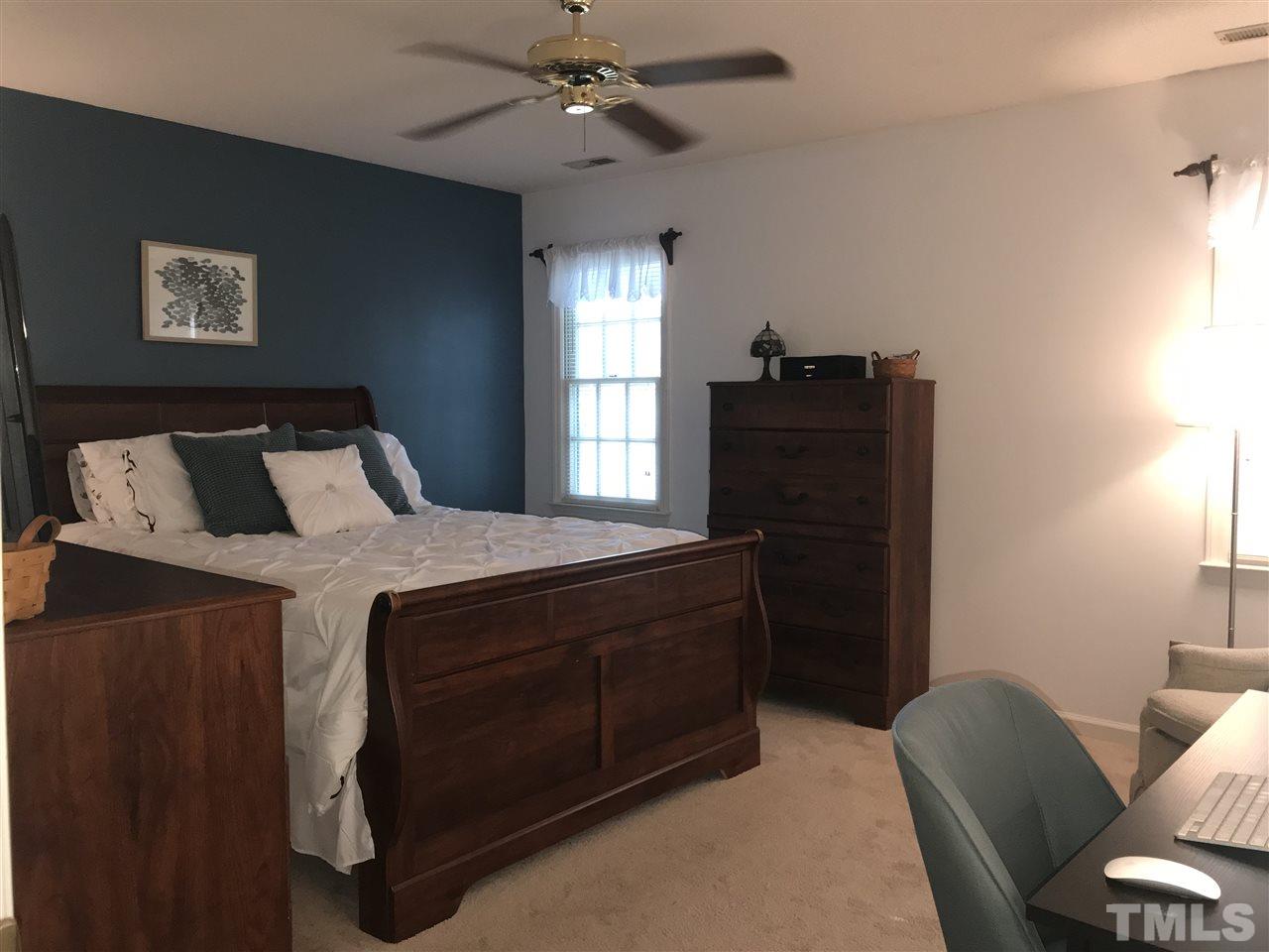 4740 Worcester Place Raleigh, NC 27604 - Photo 15 of 25 a bedroom with a bed and wooden floor