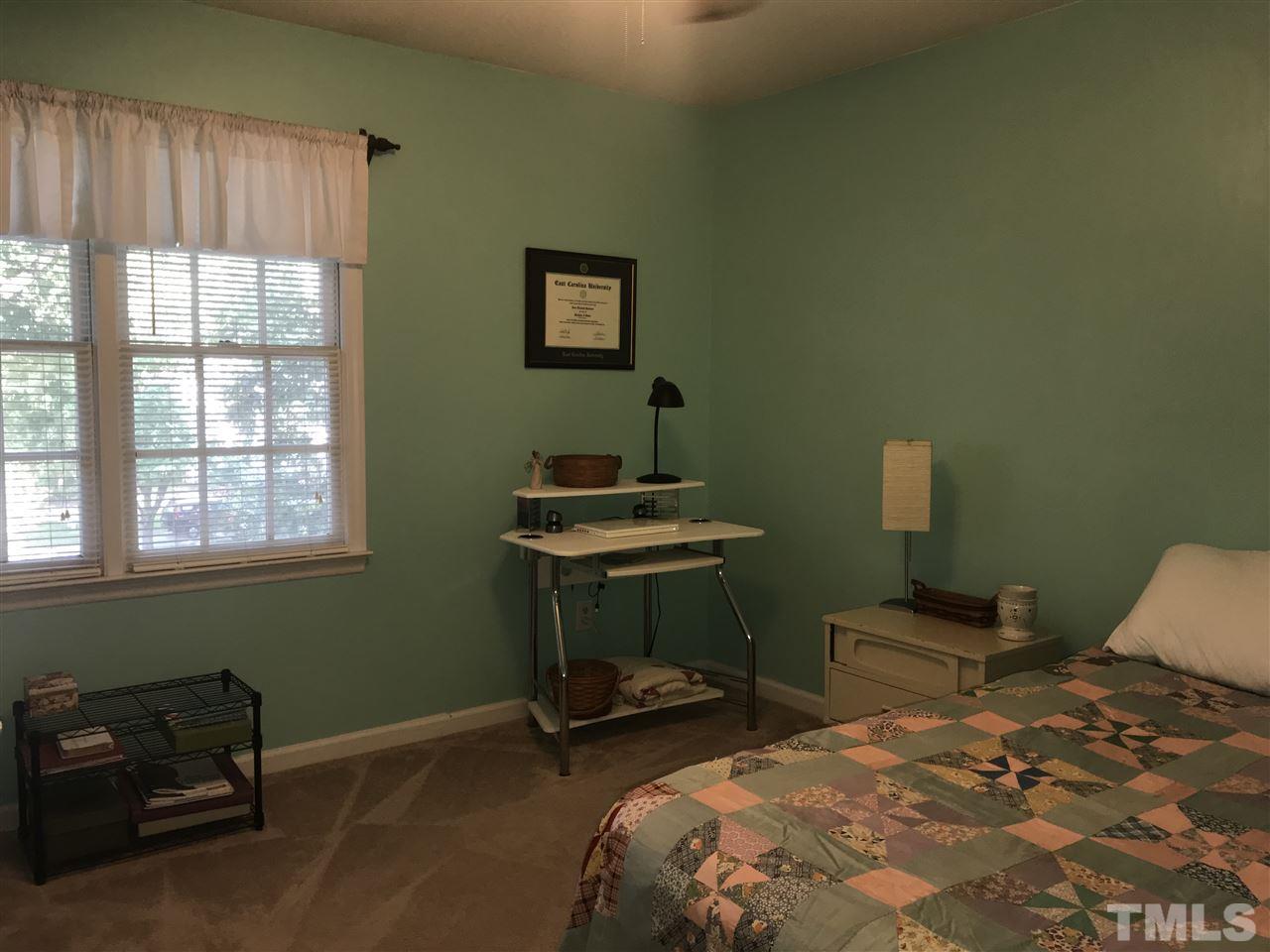 4740 Worcester Place Raleigh, NC 27604 - Photo 17 of 25 a bedroom with a bed and a window