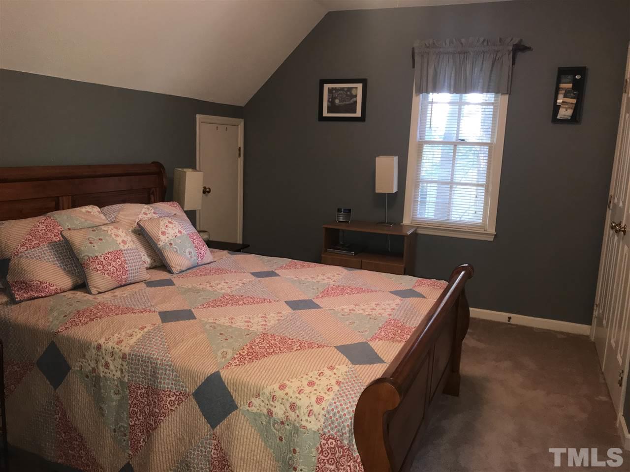 4740 Worcester Place Raleigh, NC 27604 - Photo 18 of 25 a bedroom with a bed and window