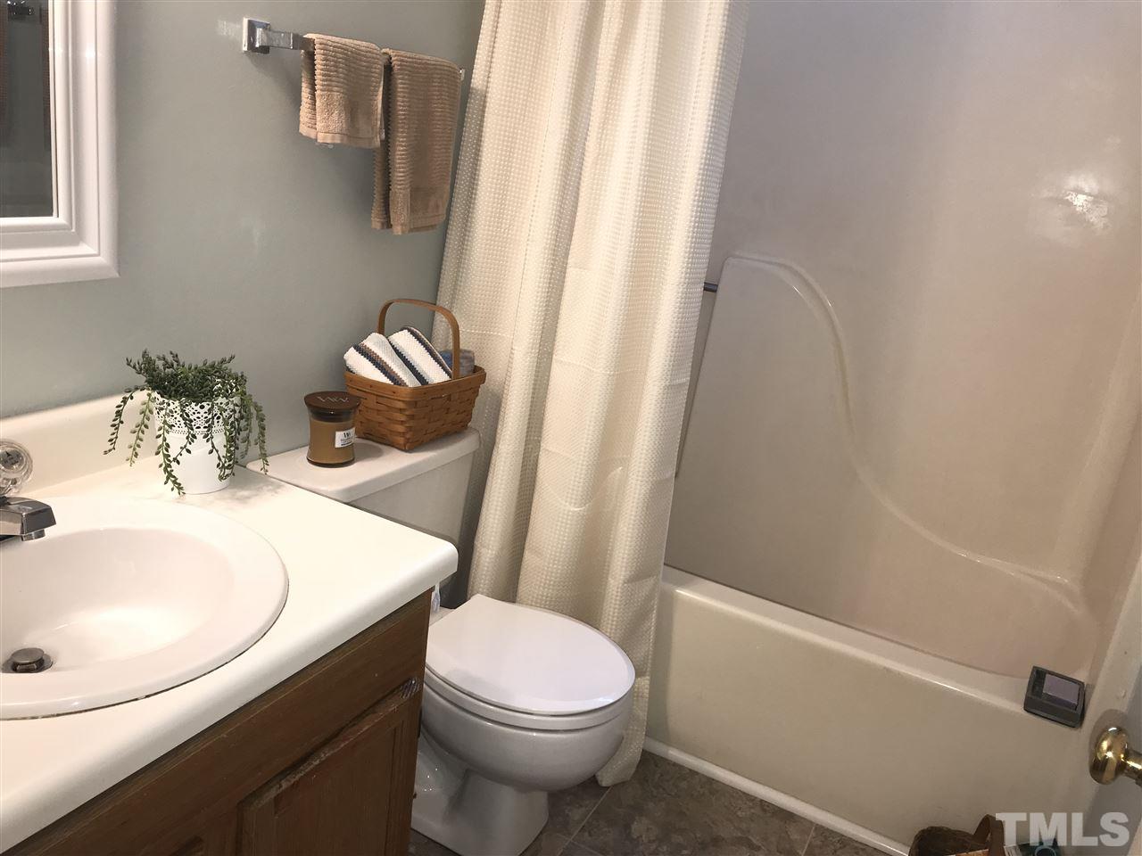 4740 Worcester Place Raleigh, NC 27604 - Photo 20 of 25 a bathroom with a sink a toilet and shower curtain
