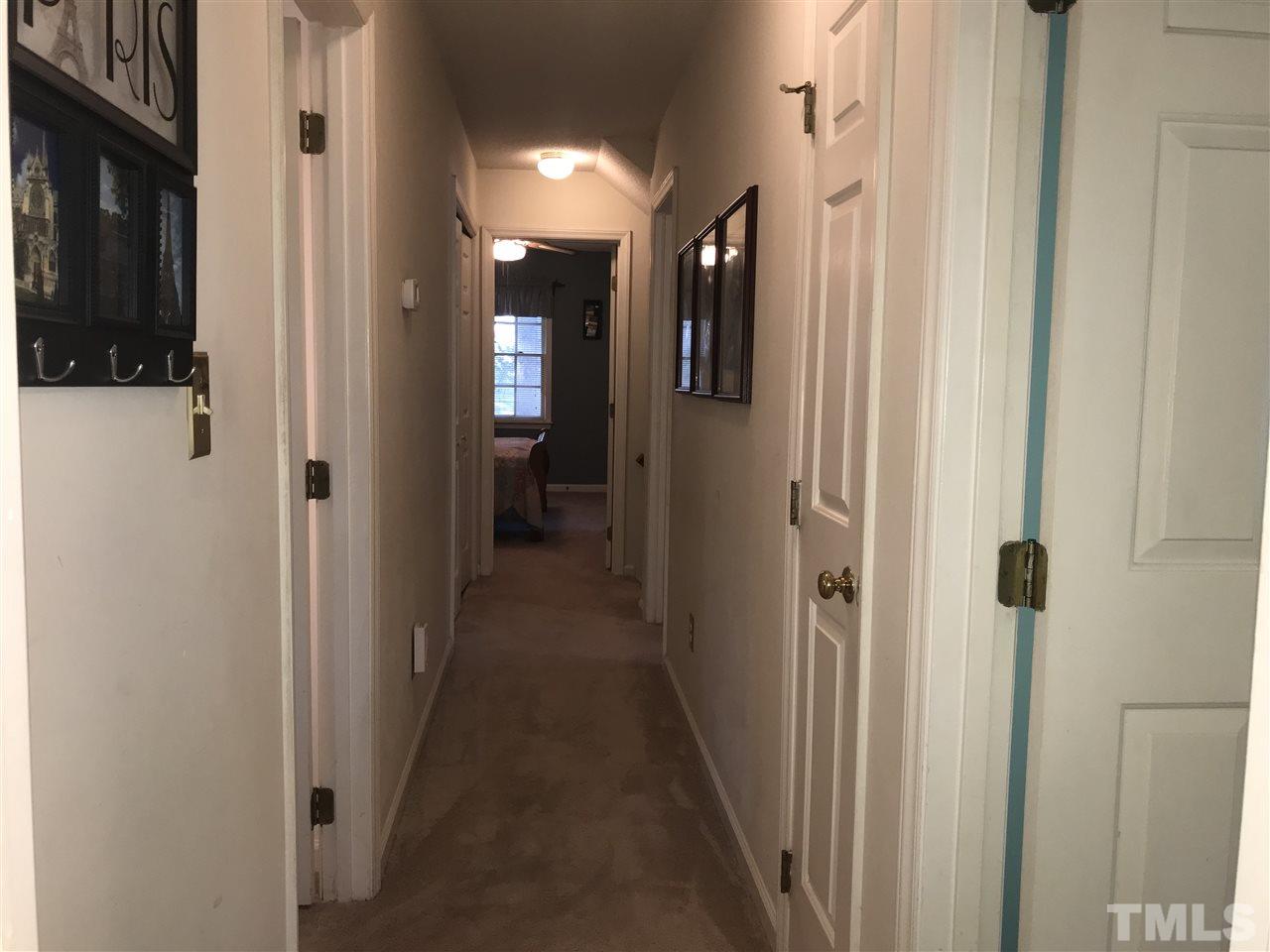 4740 Worcester Place Raleigh, NC 27604 - Photo 21 of 25 a view of a hallway with a chair and a door