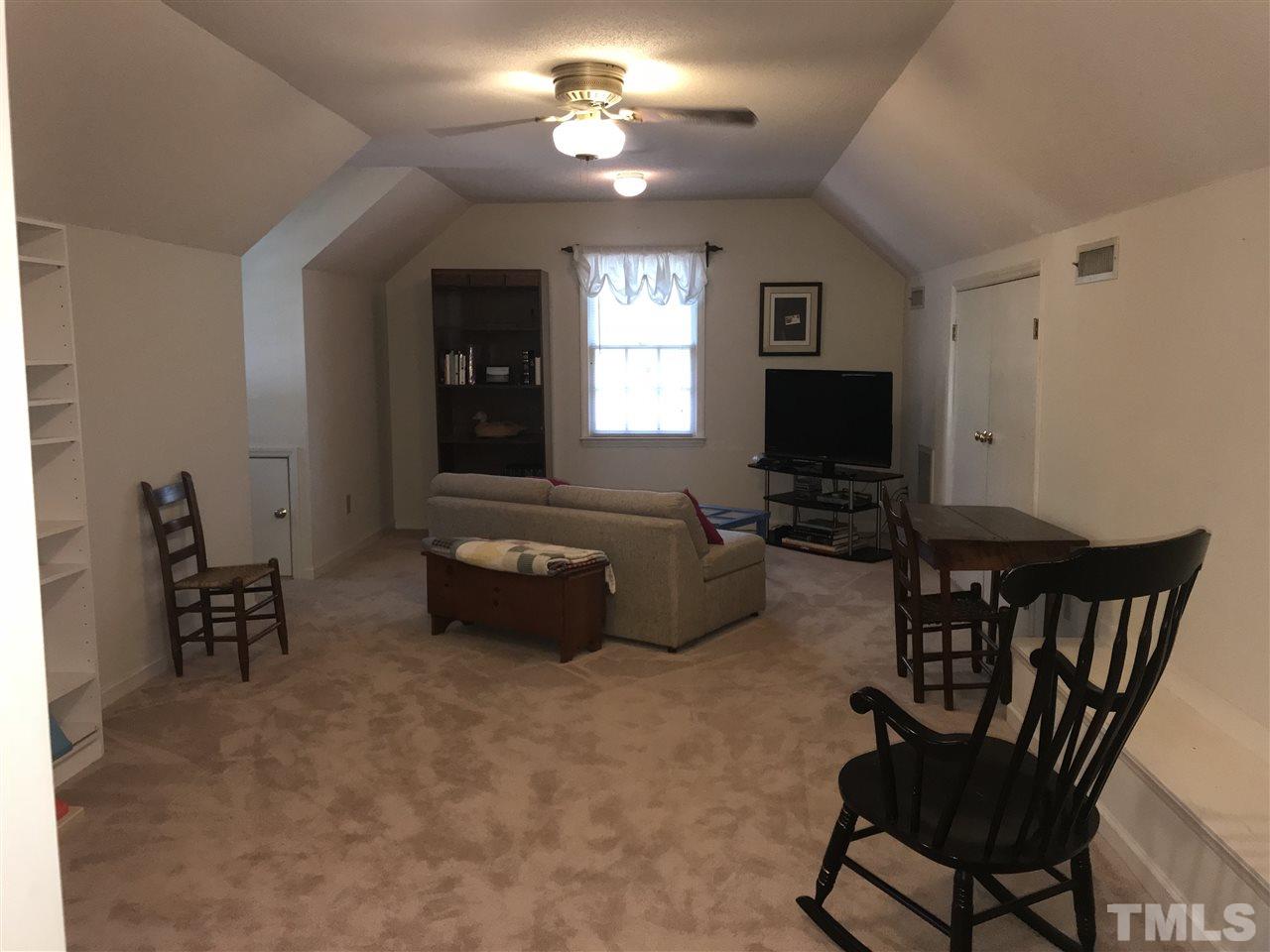4740 Worcester Place Raleigh, NC 27604 - Photo 22 of 25 a living room with furniture and a flat screen tv