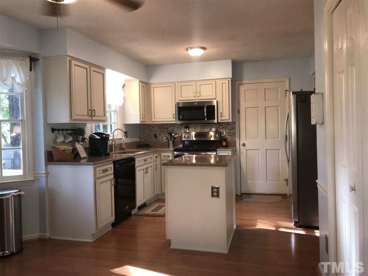 4740 Worcester Place Raleigh, NC 27604 - Photo 7 of 25 a kitchen with stainless steel appliances granite countertop a refrigerator stove and microwave