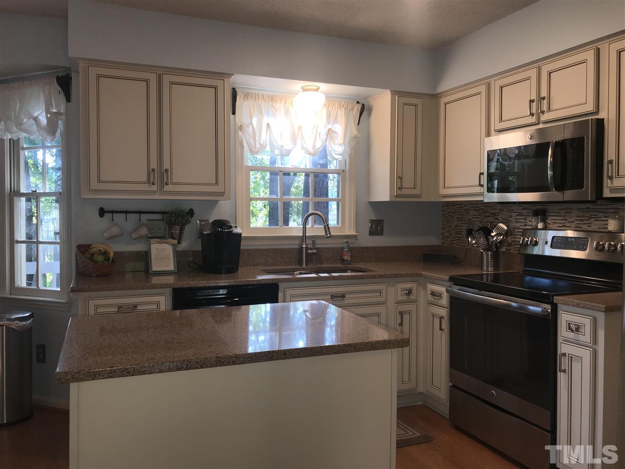 4740 Worcester Place Raleigh, NC 27604 - Photo 8 of 25 a kitchen with granite countertop a stove sink and microwave