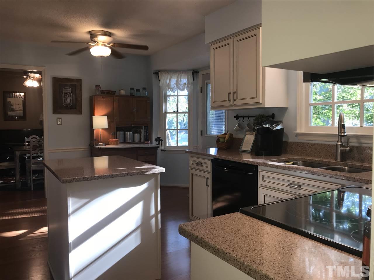 4740 Worcester Place Raleigh, NC 27604 - Photo 10 of 25 a kitchen with a stove window and cabinets