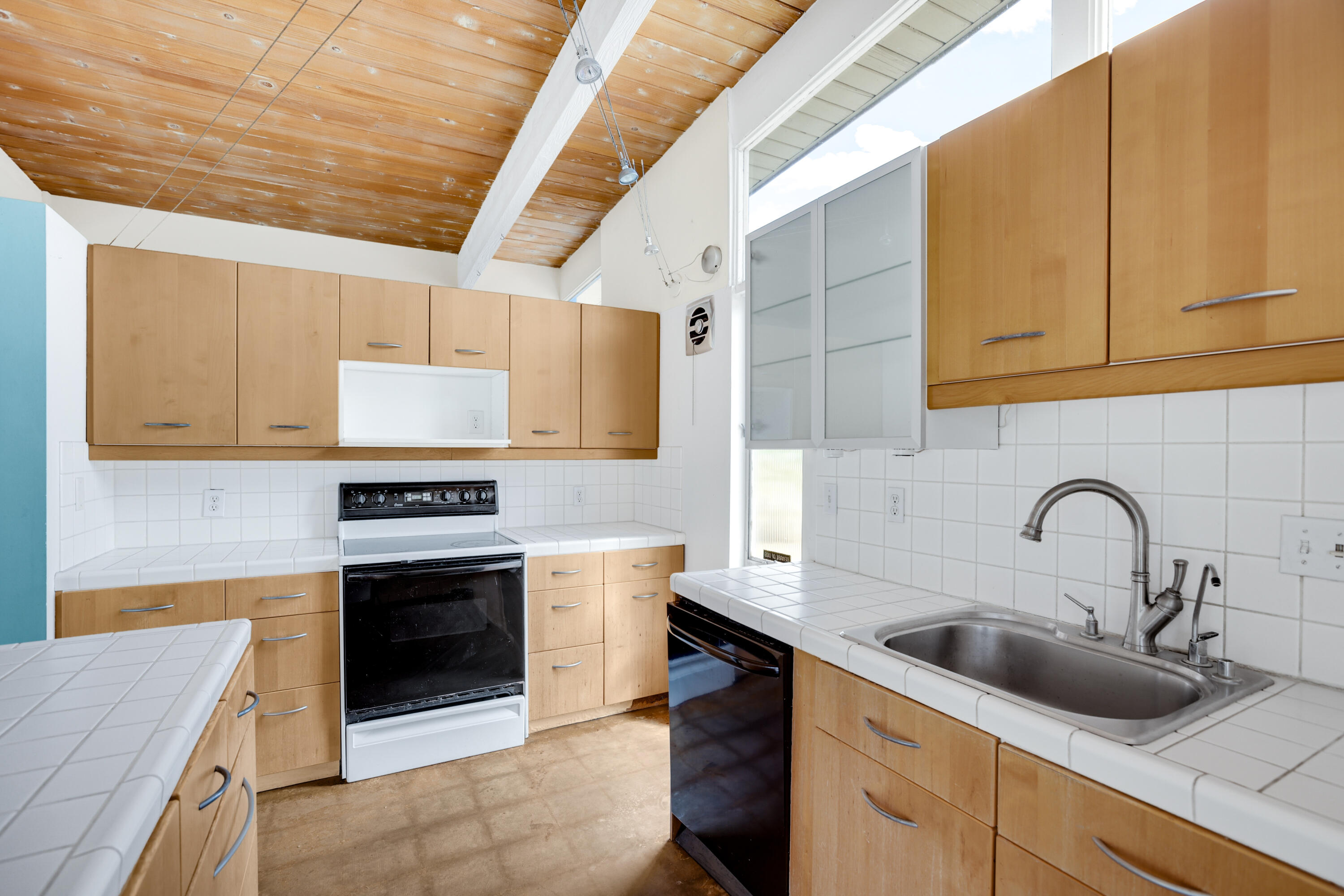 2839 North Davis Way Palm Springs, CA 92262 - Photo 13 of 29 a kitchen with stainless steel appliances granite countertop a sink stove and cabinets