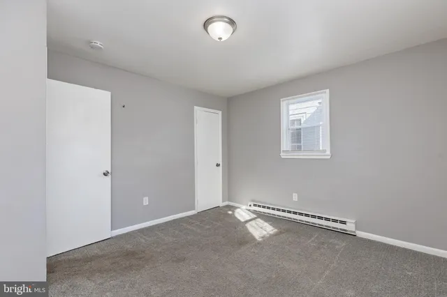 an empty room with a empty space and a window