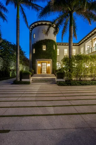 a spacious bedroom with a large bed and a chandelier