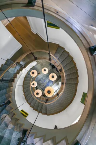 a bedroom with a bed and a dresser next to a window