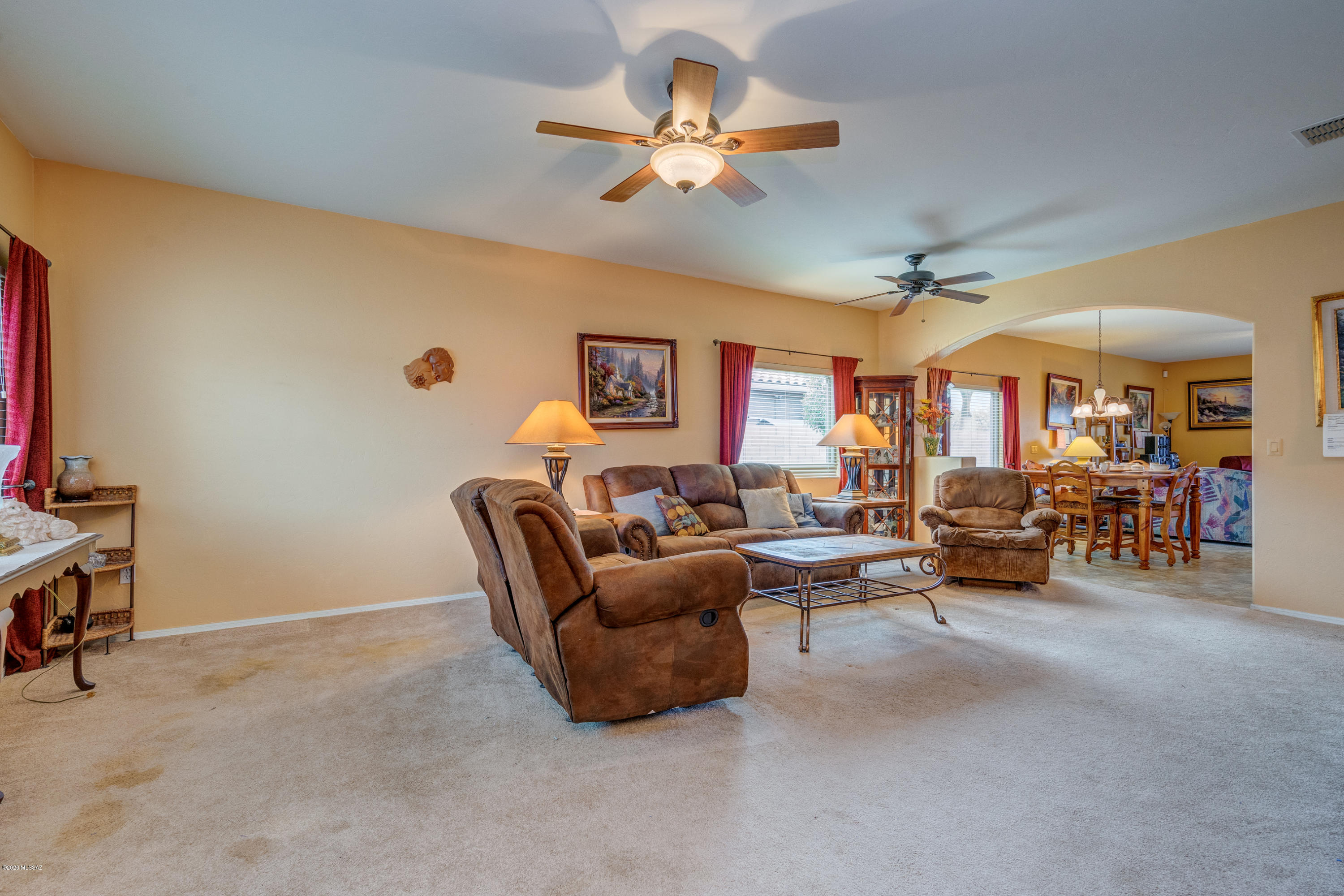 3640 East Northern Dancer Road Tucson, AZ 85739 - Photo 7 of 47 a living room with furniture and a ceiling fan
