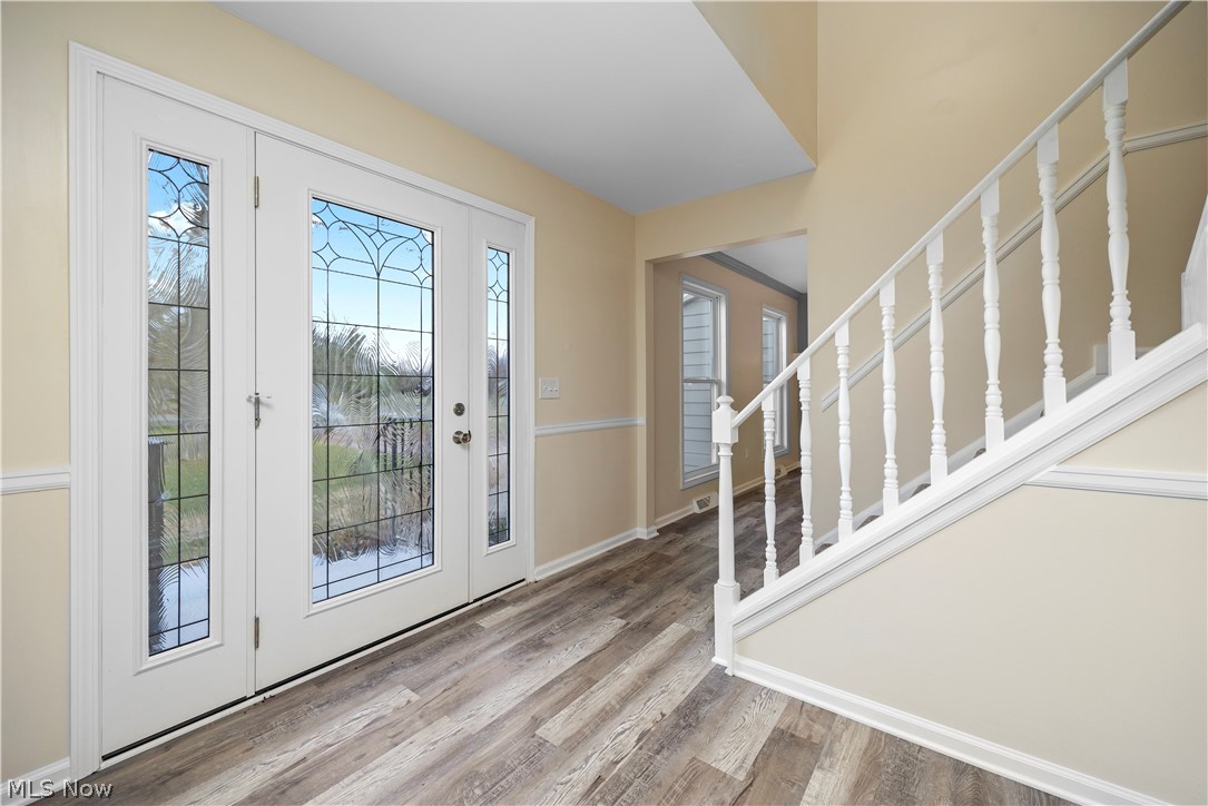 34725 Capel Road Columbia Station, OH 44028 - Photo 11 of 47 Entry foyer featuring French doors with decorative glass panels, a matching sidelight, and wood-finish flooring