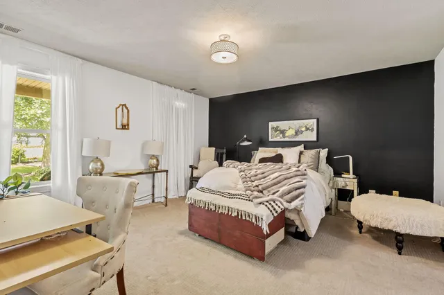 a spacious bedroom with a bed and window