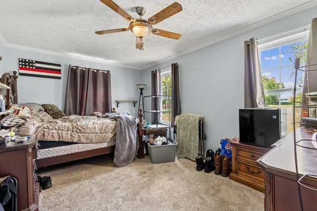 a bedroom with bed and a flat tv screen