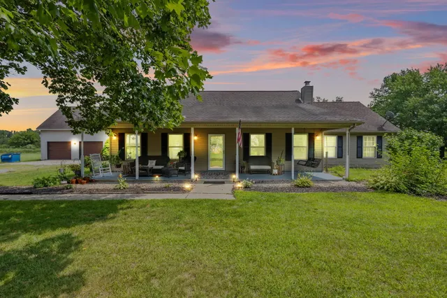a front view of a house with swimming pool having outdoor seating