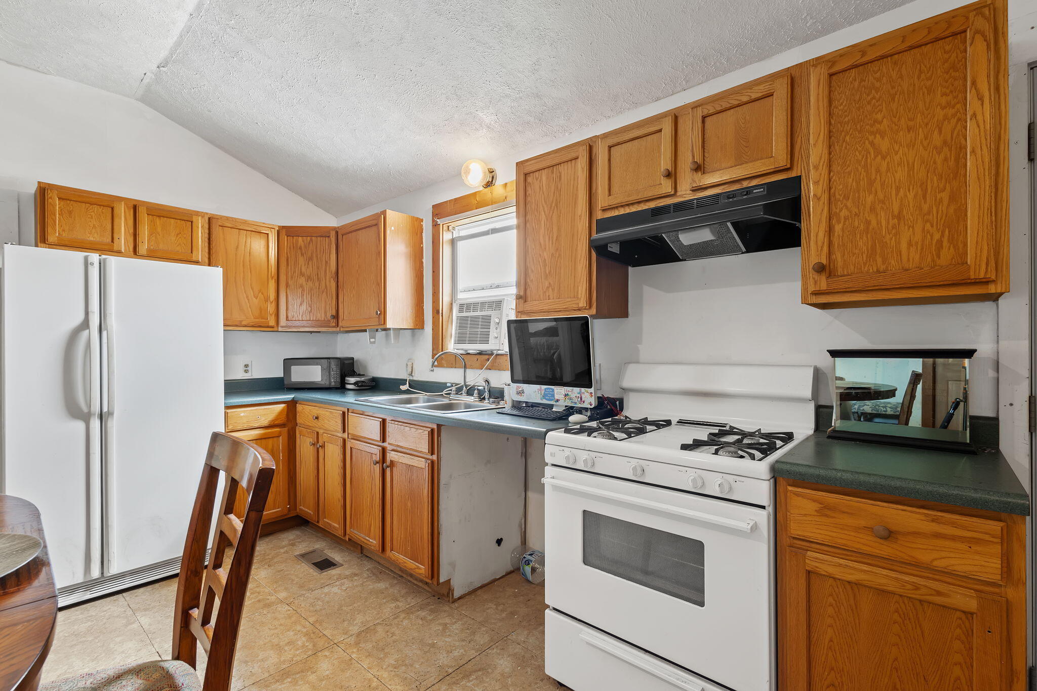 4381 Highway 231 Rensselaer, IN 47978 - Photo 22 of 30 a kitchen with stainless steel appliances granite countertop a stove a sink dishwasher and a refrigerator
