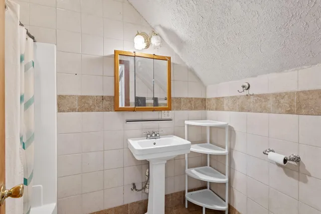 a bathroom with a sink toilet and mirror