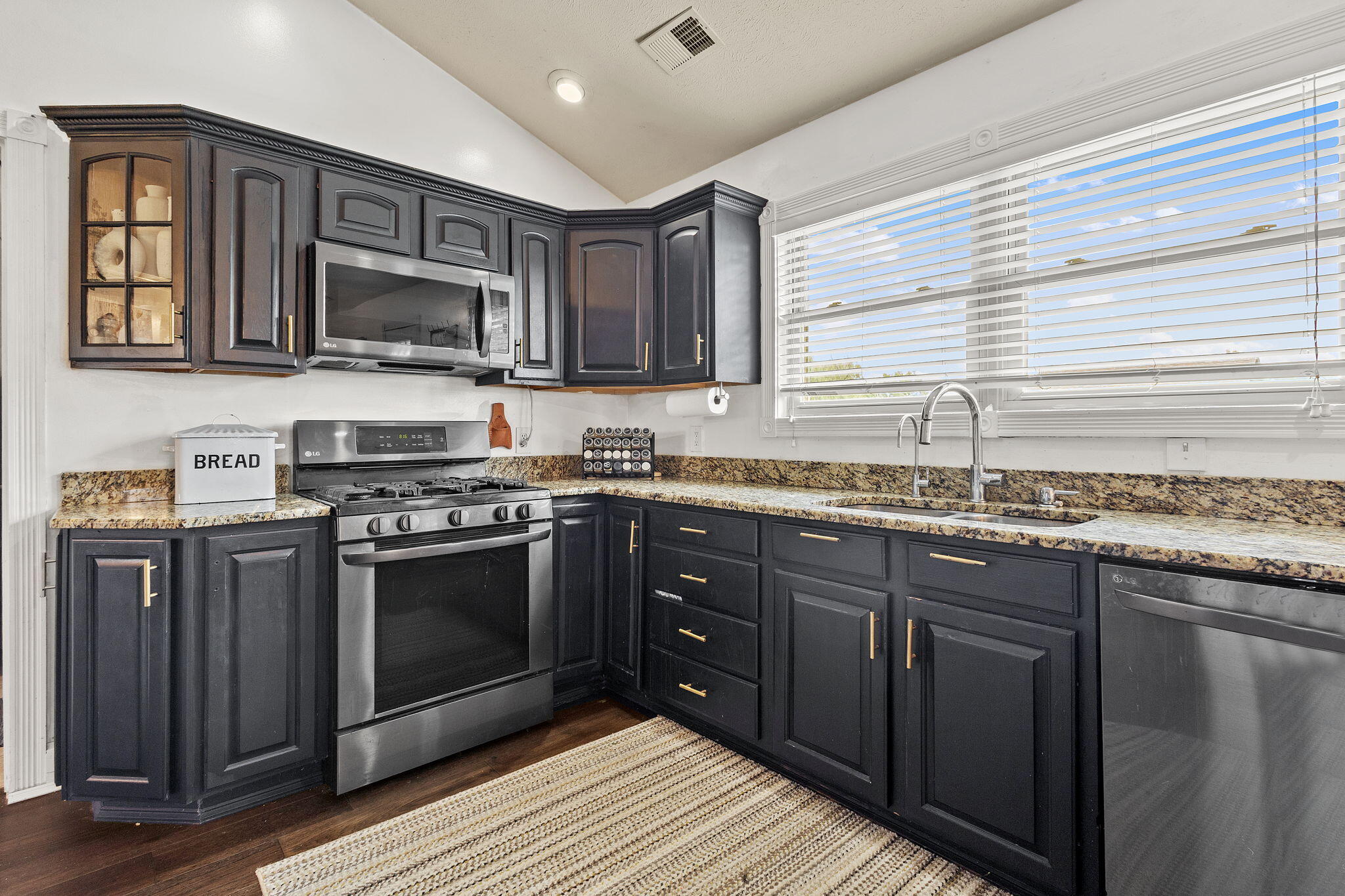 4381 Highway 231 Rensselaer, IN 47978 - Photo 7 of 30 a kitchen with stainless steel appliances granite countertop a stove microwave and sink