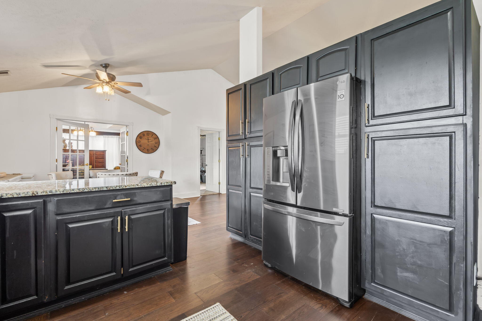 4381 Highway 231 Rensselaer, IN 47978 - Photo 8 of 30 a kitchen with granite countertop stainless steel appliances a refrigerator cabinets and wooden floor