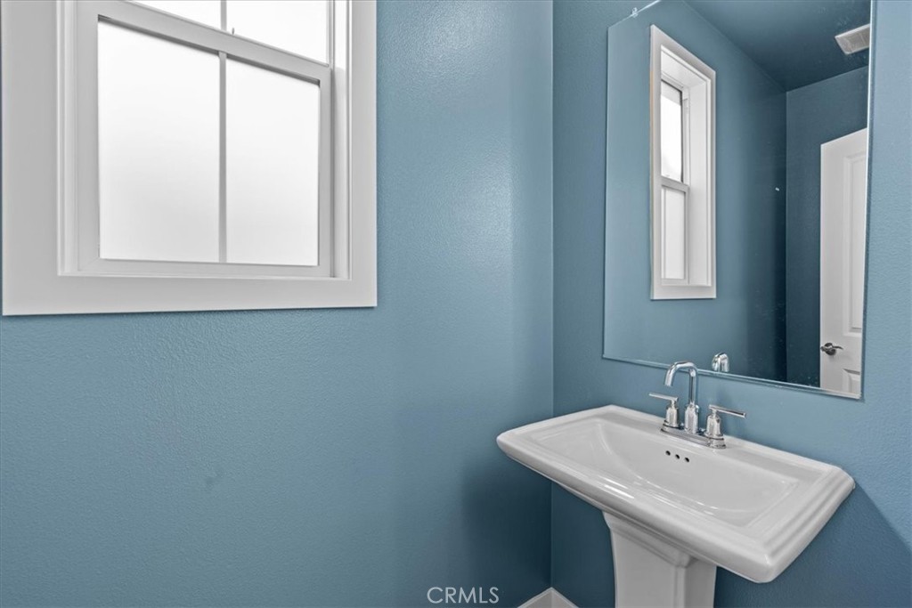 42 Concepcion Street Rancho Mission Viejo, CA 92694 - Photo 17 of 36 a bathroom with a sink a mirror and a window