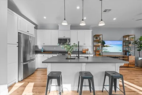 a kitchen with refrigerator and cabinets