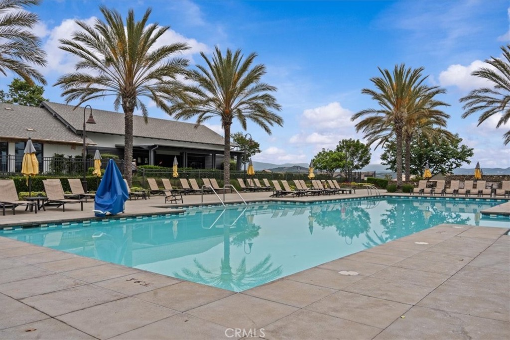 42 Concepcion Street Rancho Mission Viejo, CA 92694 - Photo 33 of 36 a view of a swimming pool with a table and chairs