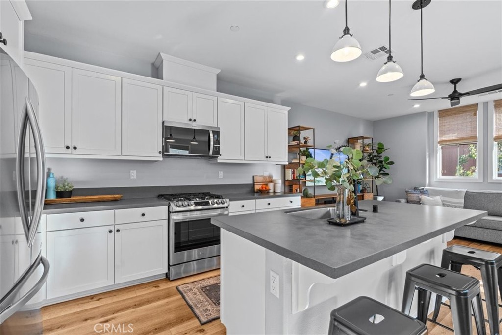 42 Concepcion Street Rancho Mission Viejo, CA 92694 - Photo 4 of 36 a kitchen with a table chairs stove and cabinets