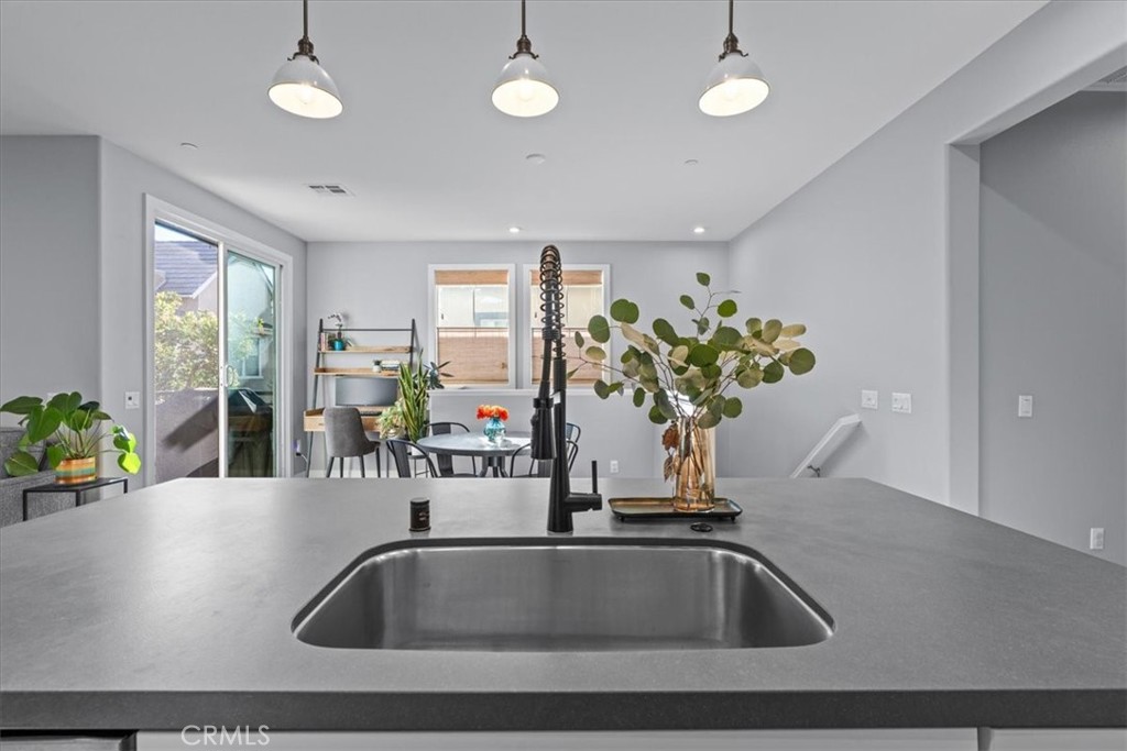 42 Concepcion Street Rancho Mission Viejo, CA 92694 - Photo 5 of 36 a close view of sink a faucet a chandelier and living room view