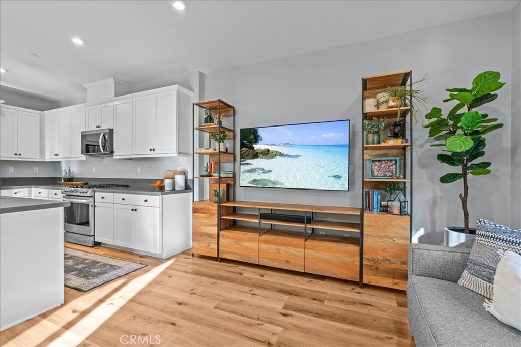 42 Concepcion Street Rancho Mission Viejo, CA 92694 - Photo 7 of 36 a kitchen with stainless steel appliances kitchen island granite countertop a refrigerator and a stove top oven