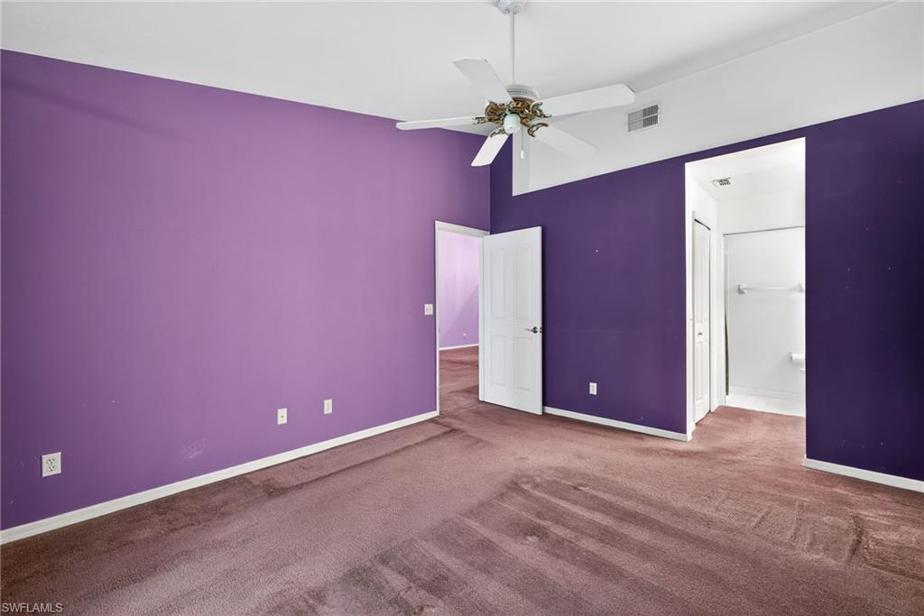 6316 Shadowood Circle Naples, FL 34112 - Photo 11 of 26 a view of an empty room with a chandelier fan