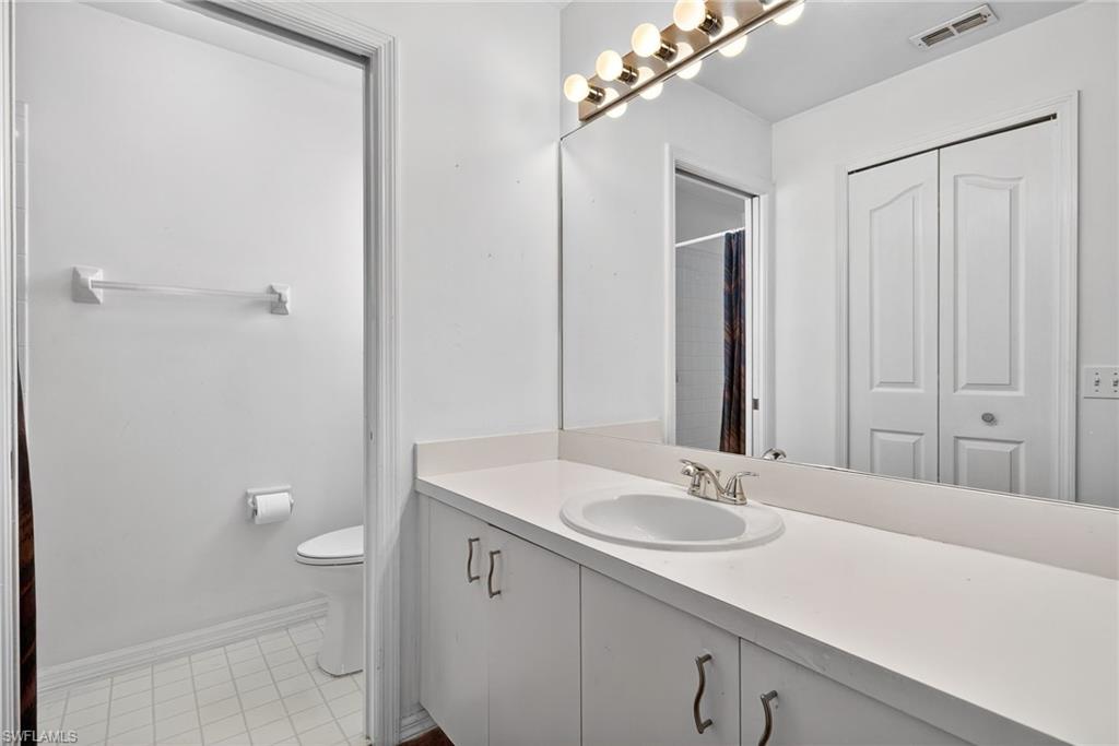 6316 Shadowood Circle Naples, FL 34112 - Photo 12 of 26 a bathroom with a sink a light fixture and a mirror
