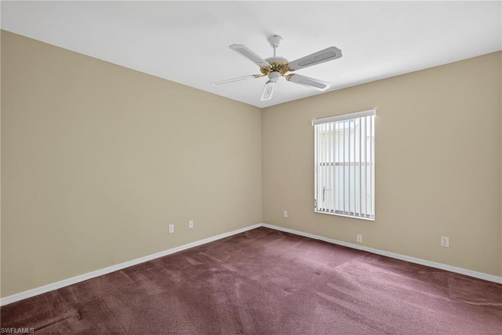 6316 Shadowood Circle Naples, FL 34112 - Photo 13 of 26 an empty room with windows and fan