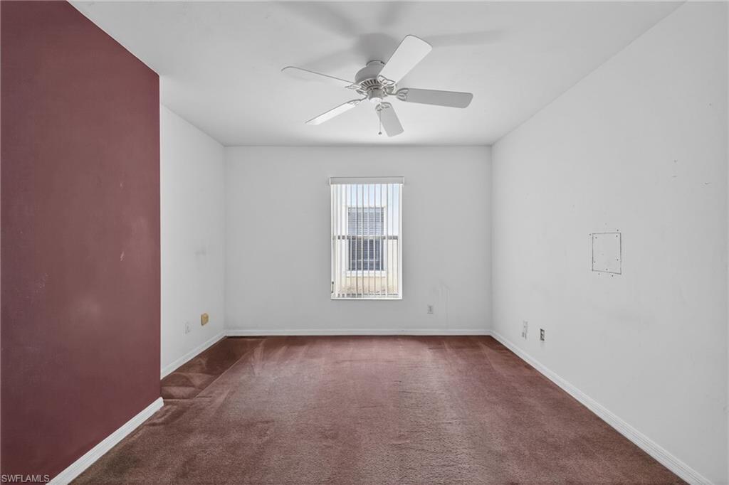 6316 Shadowood Circle Naples, FL 34112 - Photo 16 of 26 an empty room with a ceiling fan and window