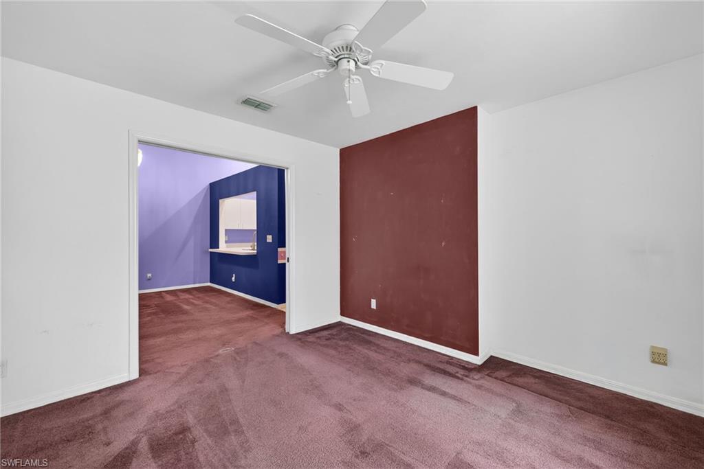6316 Shadowood Circle Naples, FL 34112 - Photo 17 of 26 an empty room with windows and fan