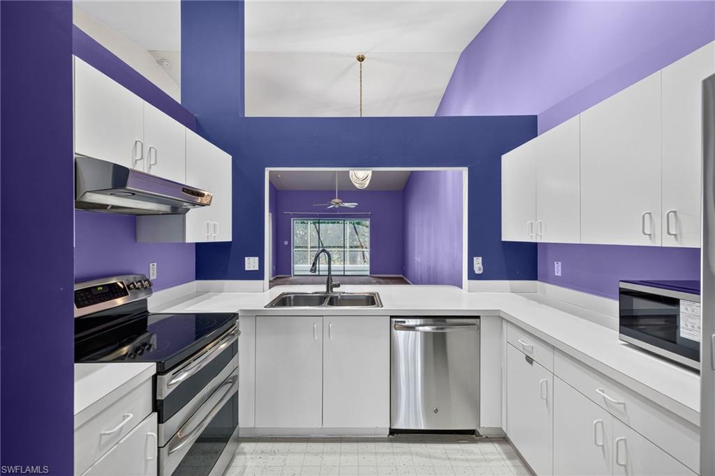 6316 Shadowood Circle Naples, FL 34112 - Photo 2 of 26 a kitchen with a sink stove and cabinets