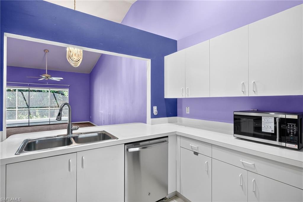 6316 Shadowood Circle Naples, FL 34112 - Photo 3 of 26 a kitchen with stainless steel appliances a sink a stove and a microwave