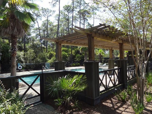 9 Redbud Ln Inlet Beach Inlet Beach, FL 32461 - Photo 6 of 7 a view of a patio with table and chairs potted plants and large tree