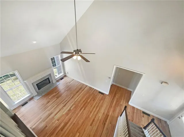 a view of a hallway with wooden floor and staircase