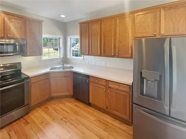 a kitchen with stainless steel appliances granite countertop a refrigerator sink and cabinets