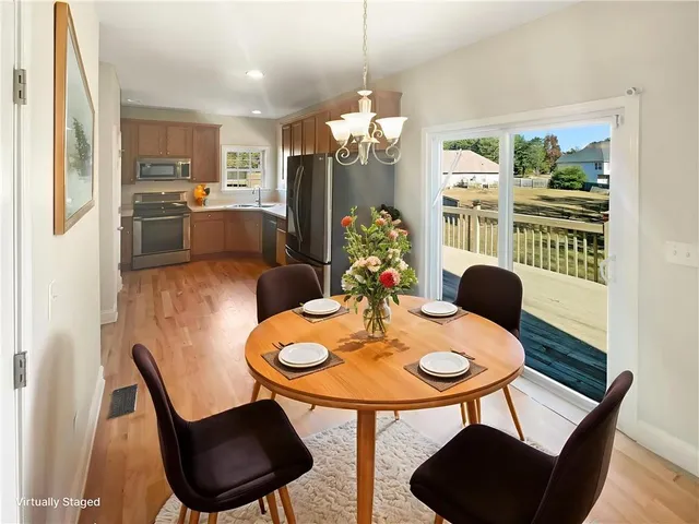 a open dining room with furniture and window