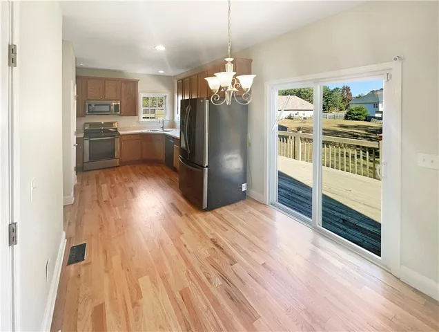 a kitchen with stainless steel appliances granite countertop a refrigerator and a sink
