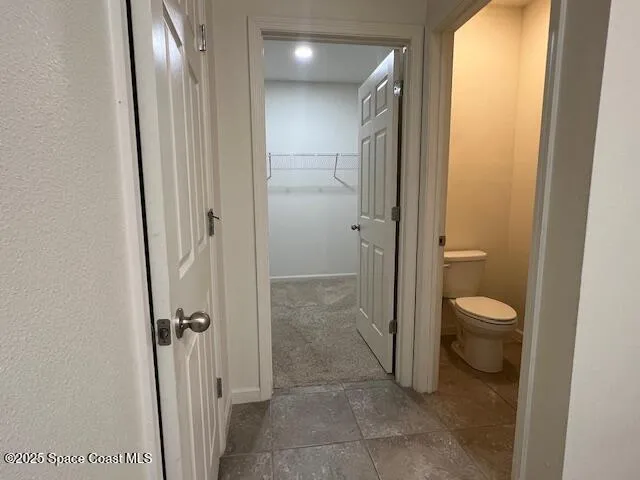 a bathroom with a granite countertop toilet and a shower