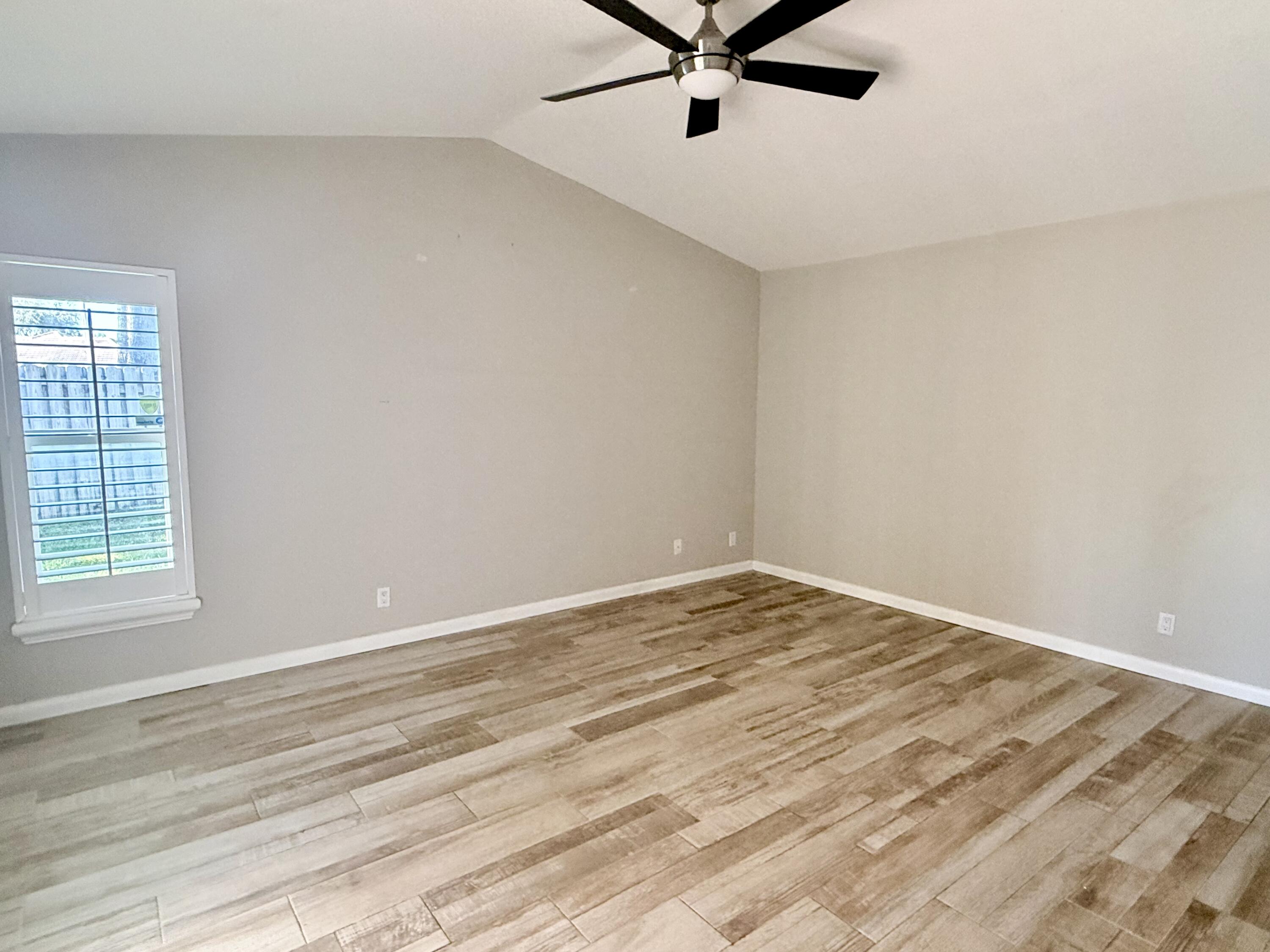 82 Sandpiper Way Boynton Beach, FL 33436 - Photo 12 of 24 a view of a room with a wooden floor and a window