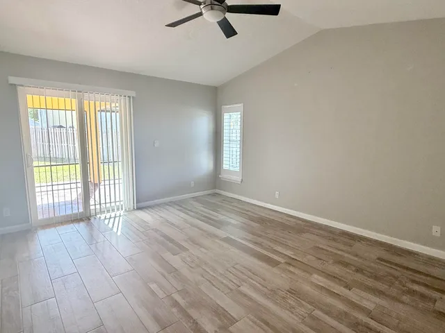 wooden floor in an empty room with a window
