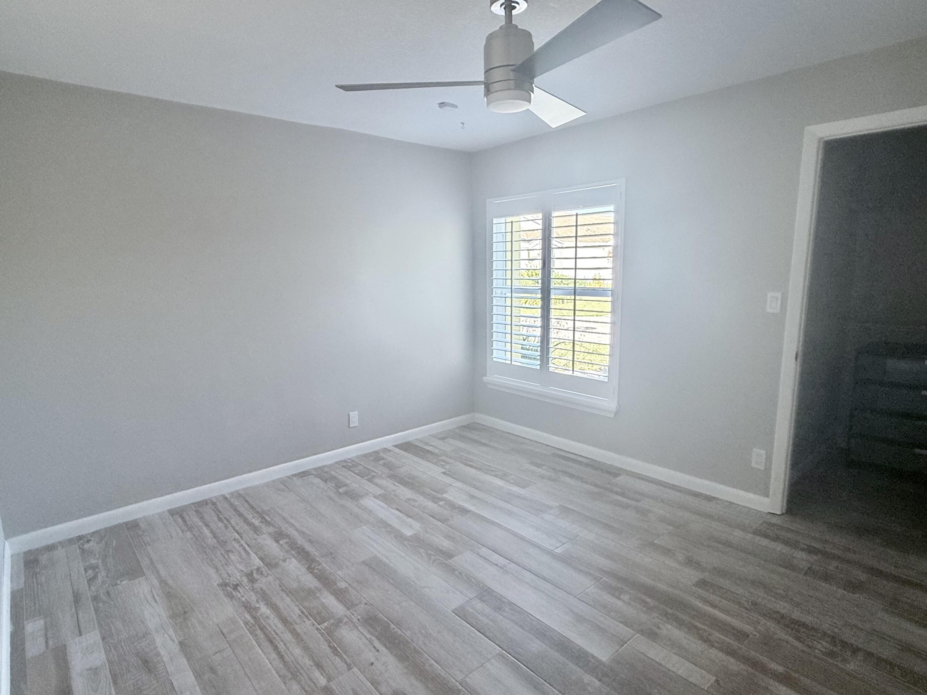82 Sandpiper Way Boynton Beach, FL 33436 - Photo 17 of 24 wooden floor in an empty room with a window