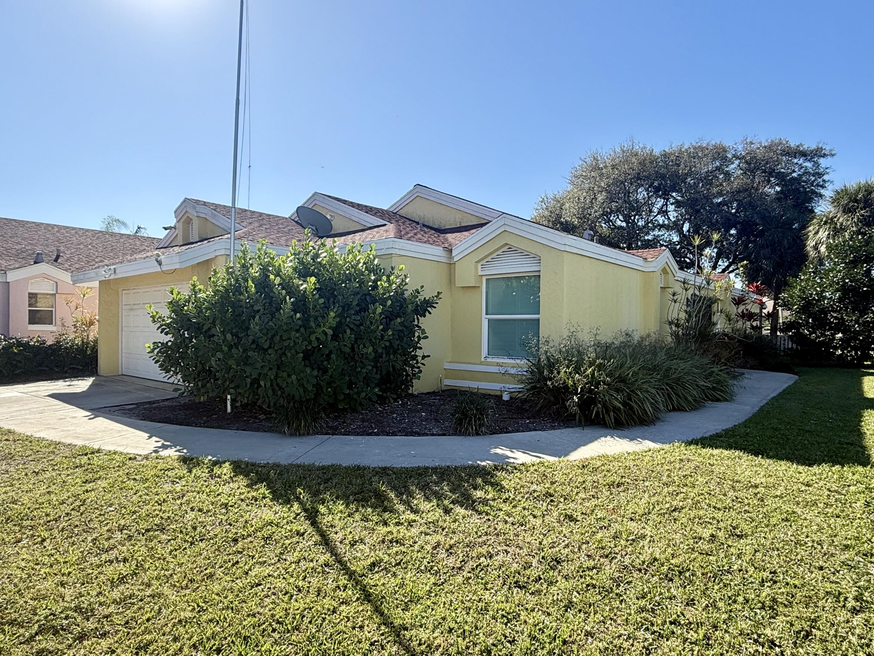 82 Sandpiper Way Boynton Beach, FL 33436 - Photo 24 of 24 a front view of a house with a yard