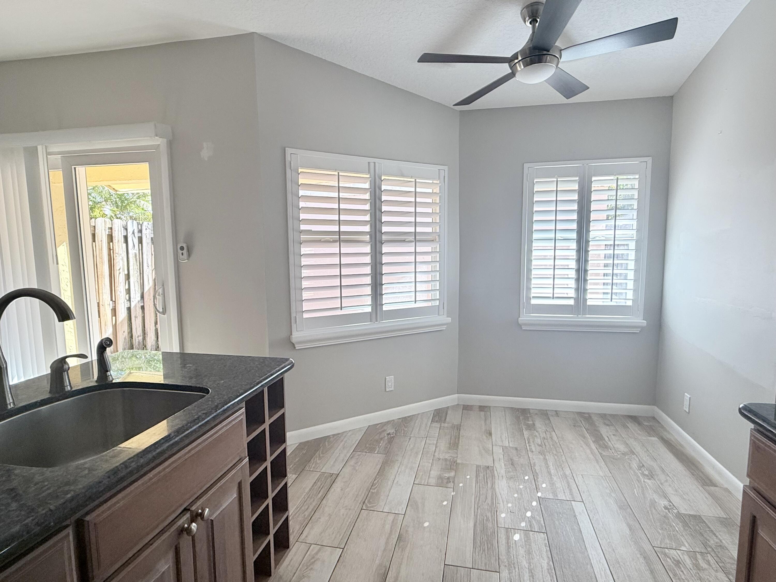 82 Sandpiper Way Boynton Beach, FL 33436 - Photo 7 of 24 a kitchen with a sink a counter top space and a window