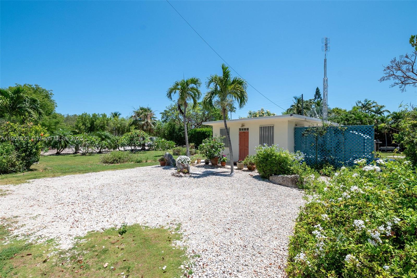 306 Lime Street Key Largo, FL 33037 - Photo 16 of 37 a view of a backyard with plants and a garden