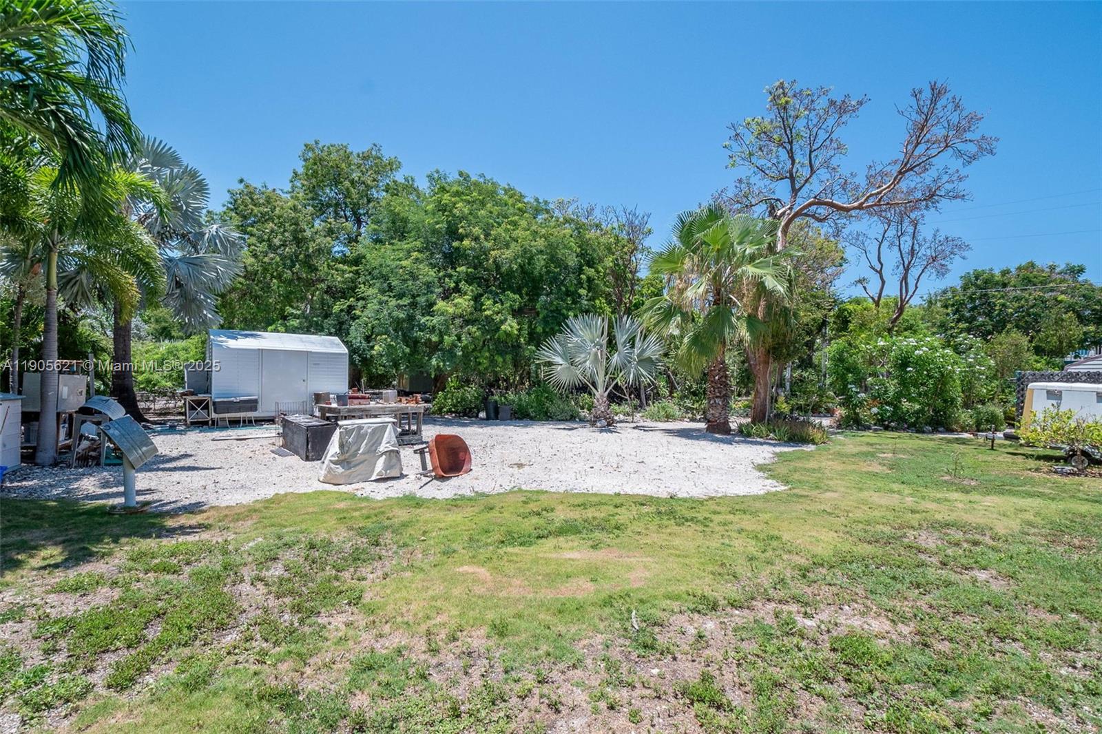 306 Lime Street Key Largo, FL 33037 - Photo 22 of 37 a view of a chairs and table in the yard